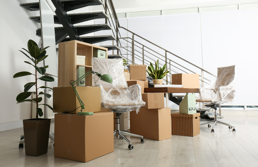 An office and all its furniture packed up and in boxes. 